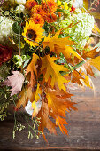 Lavish autumn bouquet of hydrangeas, chrysanthemums, sunflowers and oak leaves
