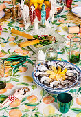 Colorfully decorated Christmas table with a Mediterranean fruit motif tablecloth