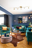 Teal sofa set in interior with blue walls