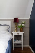 Knee wall clad in grey boards in bedroom