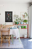 Rattan chairs around table in dining room decorated in summery pastel shades