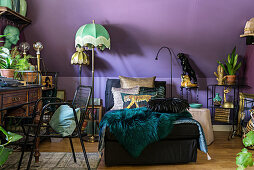 Récamier and exotic vintage-style accessories against purple knee wall