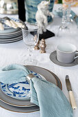Table setting with blue linen napkin and silver napkin ring