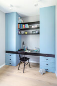 Pale blue fitted cupboards with integrated desk and shelves