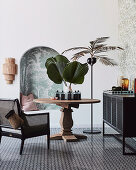 Urban jungle style seating area with wooden table and palm tree floor lamp next to alcove
