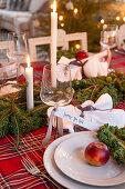 Festively set dining table decorated with kale