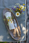 Posy of wildflowers and napkin decorated with flowers