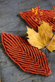 Rusty-red leaf-shaped coasters for decorating autumnal table