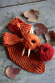 Rusty-red mug warmers and leaf-shaped coasters for decorating autumnal table