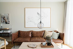 Brown leather sofa in living room in natural shades