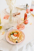 Waffles with fruit and cream on festively set table