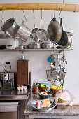 Pots and pans hung from bamboo rod in kitchen
