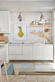 White kitchen with light wood accents and white subway tiles