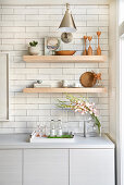 Open shelving in kitchen with white subway tiles