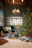 Christmas tree, gifts, side table and sofa in living room with colourful wall tiles