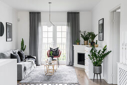 Corner fireplace and plants in classic living room in grey and white