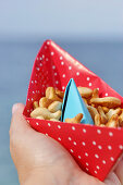 Snacks served in handmade paper boat
