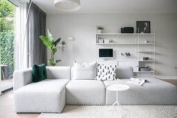Grey, modern sofa in minimalist living room