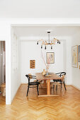 Herringbone parquet floor and vintage furniture in simple dining room