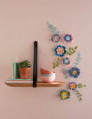 Arrangement of handmade paper flowers on wall