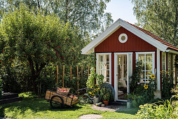 Falu-red, Scandinavian-style summerhouse in summer garden