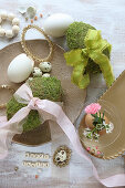 Moss eggs with ribbons and gold Easter decorations