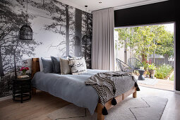 Photo mural with woodland motif in bedroom with access to gaarden
