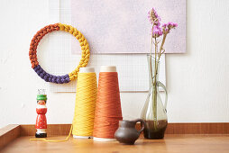 Multicoloured decorative ring made from knitted tubes made using knitting dolly