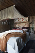 Canopy over comfortable bed in rustic bedroom