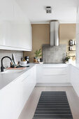 White, U-shaped, fitted galley kitchen