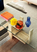 Coffee table with travertine frame and glass top