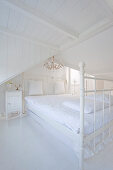 Double bed in white, shabby-chic, attic bedroom