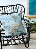 Homemade pillow with map motif on a black rattan chair