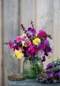 Summer bouquet of sweet peas, everlasting flowers, asters, goldenrod and spinach seeds