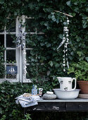 Rustic washing station on an old table at the garden shed with ivy