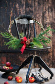 DIY Christmas wreath made of branches, coniferous twigs, and cones with a bow