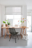 Wooden table with chair in front of the window