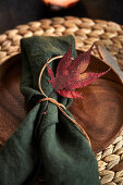 A place setting decorated with an autumn leaf
