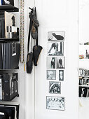 Ballet shoes hanging next to a bookcase and black-and-white photos