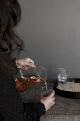 Woman pouring herself a glass of mulled wine