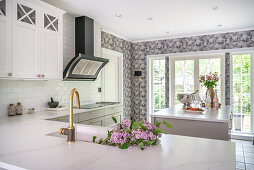 Bright fitted kitchen with L-shaped counter
