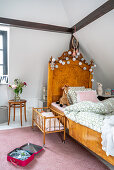 Antique wooden bed and dolls' bed in girl's bedroom