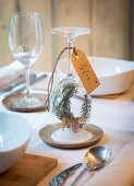 DIY place card with winter landscape under upturned wine glass