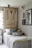 Bohemian-style child's bedroom with old door used as bed headboard