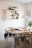 Fur blankets on designer chairs at table in Boho-style dining room