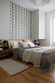 Wallpaper with graphic pattern in bedroom in natural shades