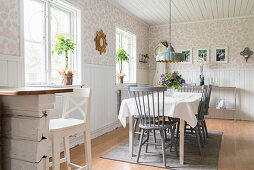 Grey spoke-back chairs around table in country-house-style dining room