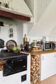 Old, wood-fired stove in rustic, country-house-style kitchen