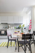 White kitchen decorated with sophisticated splashes of colour and geometric patterns