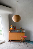 Retro drinks cabinet in living room with organically formed walls